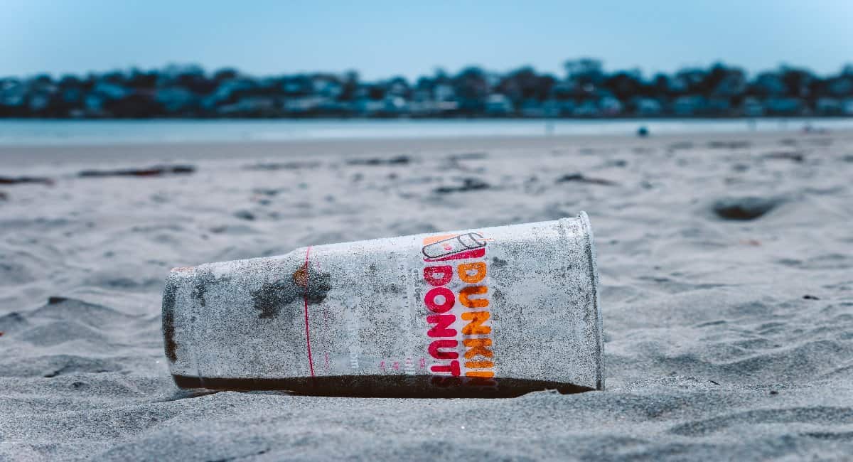 Single use plastic cup littering the beach